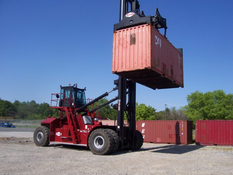 Sea container being loaded by transport vehicle