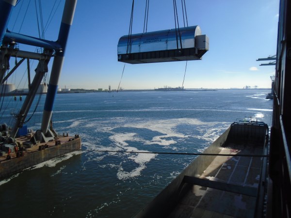 Heavy cargo is loaded with a crane